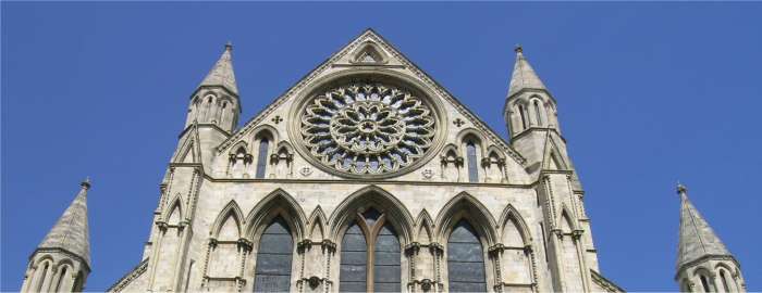 Picture of the Rose Window of York Minster. A blue sky as a backdrop on a warm and sunny July day and the south trancept of York Minster lights up as does the rose window inside and out. Click for larger image.